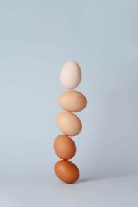 balancing tower of eggs representing female hormones